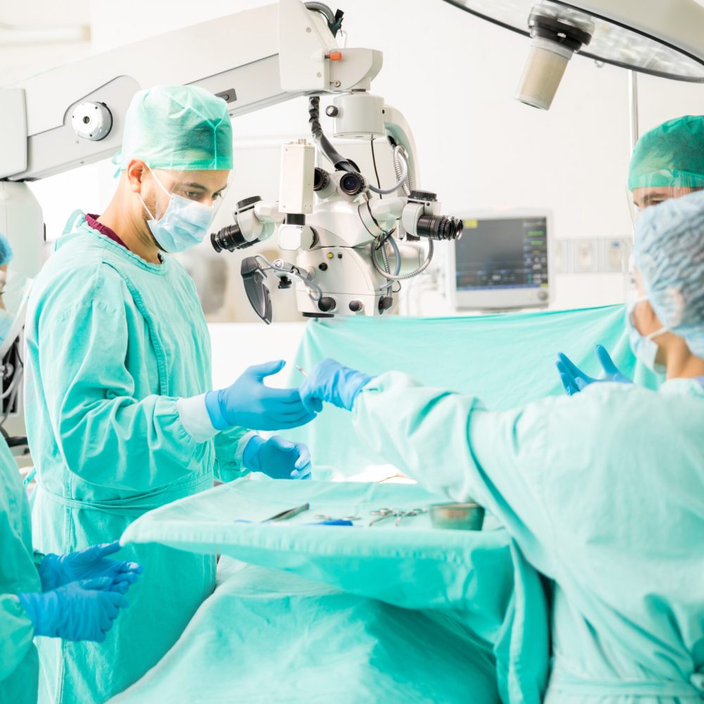 Team of doctors working together during a heart surgery in an operating room at a hospital